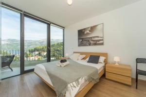 a bedroom with a bed and a large window at White Cloud Apartments in Korčula