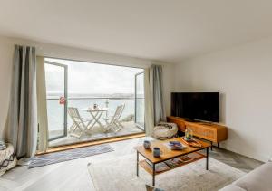 a living room with a large window with a view of the ocean at A7 Masts in Torquay