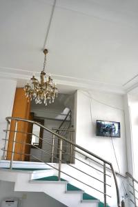 a staircase with a chandelier in a building at 21 На удачу in Rustavi
