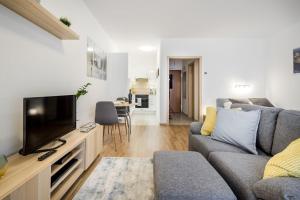 a living room with a couch and a tv at Marina apartment at Danube - FREE PRIVATE PARKING! in Budapest