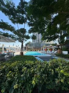 a swimming pool with a tree in the middle at The address opera t1 burj khalifa in Dubai