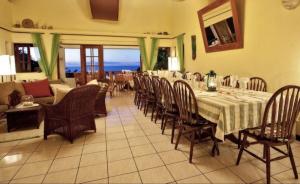a dining room with a long table and chairs at Amazing 9 BR Villa in Cap Estate in Cap Estate