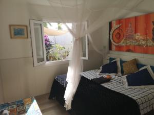 a bedroom with two beds and a window at Yumbo room in Maspalomas