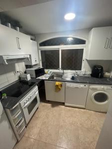 a small kitchen with a sink and a dishwasher at Habitación privada en piso compartido Madrid in Madrid