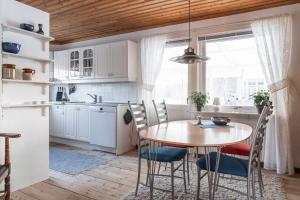 a kitchen with a table and chairs and a window at Holiday home within walking distance to sandy beach in Båstad