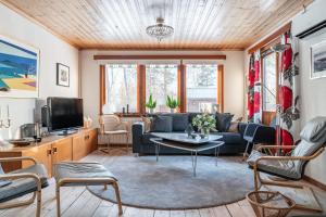 a living room with a couch and a table at Holiday home within walking distance to sandy beach in Båstad