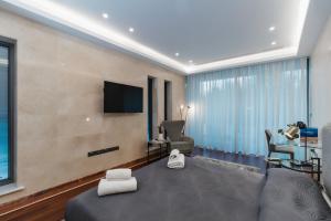 a hotel room with a bed and a flat screen tv at 16 EXECUTIVE SUITES in Nicosia