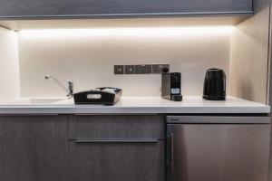 a kitchen with a sink and a coffee maker on a counter at 16 EXECUTIVE SUITES in Nicosia