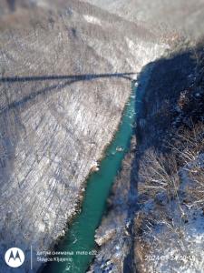 an aerial view of a river in a field at Family owned self sufficient ECO farm TARA in Pljevlja