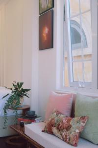 a living room with a couch and a window at Le Macaron Boutique Hotel Đà Lạt - Dalat in Da Lat