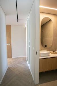 a bathroom with a sink and a mirror at High End 1BD Beach Apartment in Tel Aviv