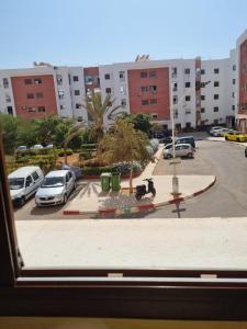 a view from a window of a parking lot with cars at Residence salam in Agadir
