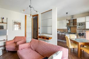 a living room with a couch and a table at Mestre Cozy Apartment with Parking! in Marghera