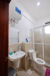 a bathroom with a toilet and a sink at 1 Bedroom Lake Victoria View Apartment in Entebbe