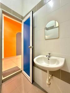 a bathroom with a sink and a mirror and a shower at Ipoh IGB Homestay by Comfort Home in Ipoh