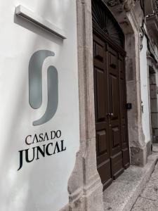 a door to a building with the csa do jumancil at Casa do Juncal in Guimarães