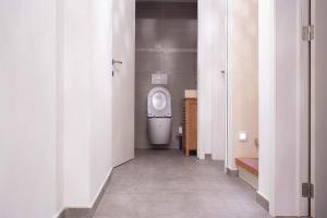 a bathroom with a white toilet in a room at Maison 3 chambres proximité aéroport et grand axes in Charleroi