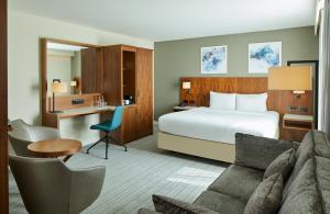 a hotel room with a bed and a desk at Courtyard by Marriott London Gatwick Airport in Horley