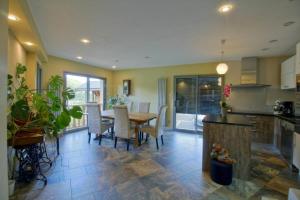 a kitchen and dining room with a table and chairs at chambres d'hôtes las Vignes in Beaucens