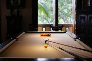 a pool table with a ball in the middle of it at Villa Patria in Lovina