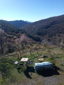 a picnic table and chairs on top of a hill at Apartamentos Balcon del Cielo in Trevélez