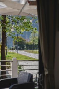 a view of a road from a porch with a window at Al Lago Camping & Rooms in Riva del Garda