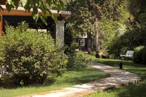 Um jardim em Heura Petit Hotel