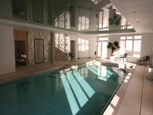 a large swimming pool in a large building at Domitys Les Craies Blanches in Mont-de-Marsan