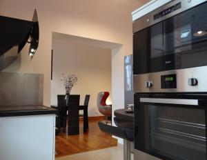 a kitchen with a large oven and a dining room at L'esprit d'antan, quartier historique deux personnes in Chartres