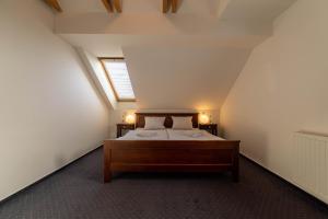 Postel nebo postele na pokoji v ubytování Hotel Liptov Holiday ***