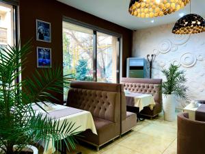 a waiting room with a couch and a table at Hotel FN Shymkent in Shymkent