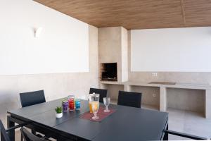 a dining room with a black table and chairs at MalagaSuite Villa Nomada El Torcal in Antequera