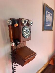a wooden telephone hanging on a wall at Relaxation Holiday Home in Bellerive in Bellerive