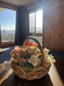 a basket of flowers on a table in a room at Relaxation Holiday Home in Bellerive in Bellerive