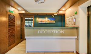 a reception area of a restaurant with a reception desk at Hotel Aura - Near Malad Link Road in Mumbai