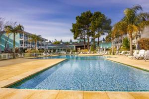 an image of a swimming pool at a resort at Howard Johnson Hotel & Convention Center Madariaga - Carilo in Carilo