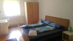 a bed in a room with two pillows on it at Rooming Green Weyregg in Weyregg