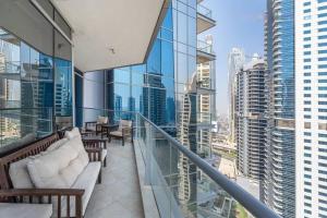 a balcony with furniture and a view of a city at Trident Grand Residence,Dubai Marina - 3BR Apartment - Allsopp&Allsopp in Dubai