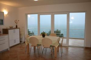 a kitchen and dining room with a table and chairs at Apartments Boris in Omiš