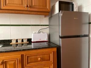 a kitchen with a refrigerator and a toaster on a counter at Germanies Home, Algemesi Home in Algemesí