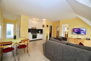 a living room with a couch and a table at Haus Sonne Ferienwohnung 5 in Thiessow