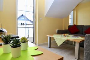 a living room with a couch and a table at Haus Sonne Ferienwohnung 5 in Thiessow