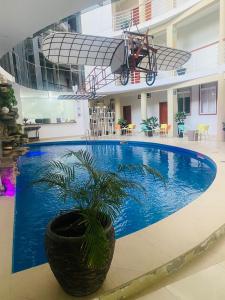 a swimming pool in a building with a bike in the air at VUELO 78 HOTEL in Tarapoto