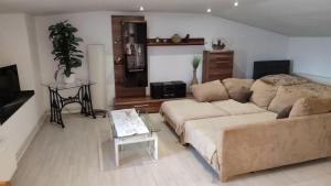 a living room with a couch and a table at Leipzig-Neuseeland-Ferienwohnung in Rötha