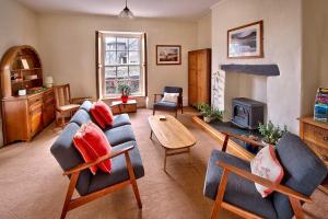 a living room with couches and a fire place at Dol Peris in Llanberis