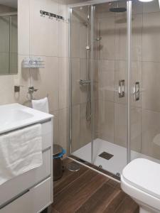 a bathroom with a shower and a toilet and a sink at El Indio Chocolatería Boutique in Pinto
