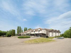 a large house with a driveway in front of it at ibis Styles Sarrebourg in Sarrebourg