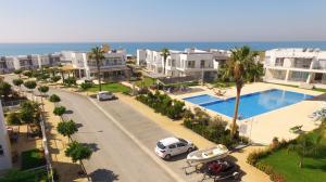 an aerial view of a street with houses and a pool at Трехкомнатные апартаменты в жилом комплексе Caesar Beach F14 Flat4 in Boğaz