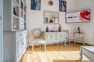 a room with a dresser and a table and chairs at Jelena Apartments By The Sea in Agios Nikolaos +44 photos