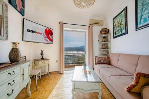 a living room with a couch and a table at Jelena Apartments By The Sea in Agios Nikolaos
